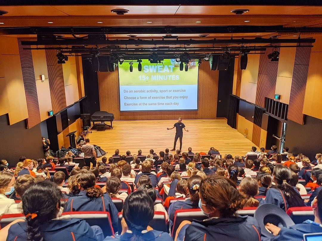 James presenting to a school auditorium